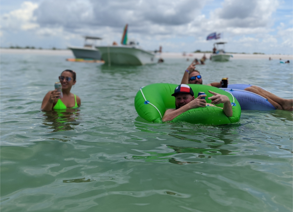 Aquatic Escapes guests floating off a Tampa Bay sandbar on an island hopping trip