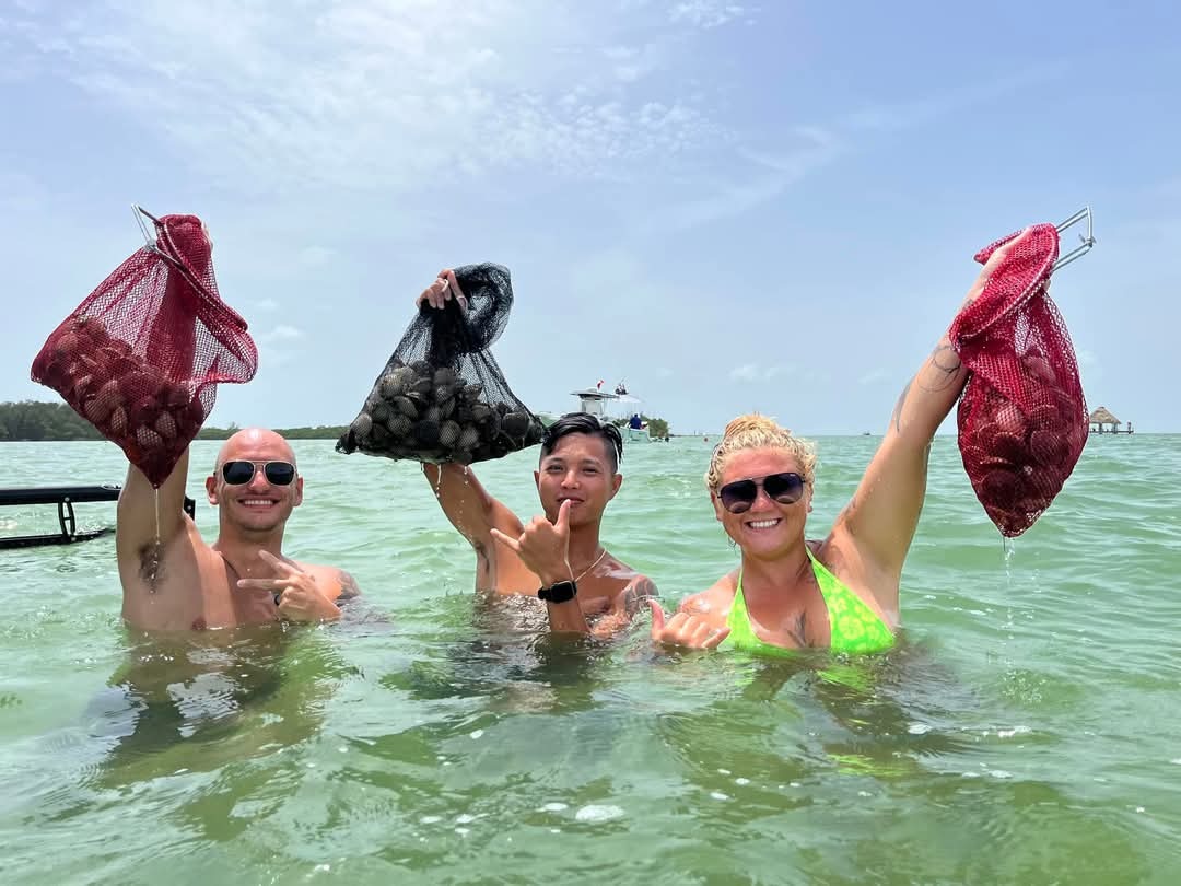 An Aquatic Escapes group holding up their bags of bay scallops