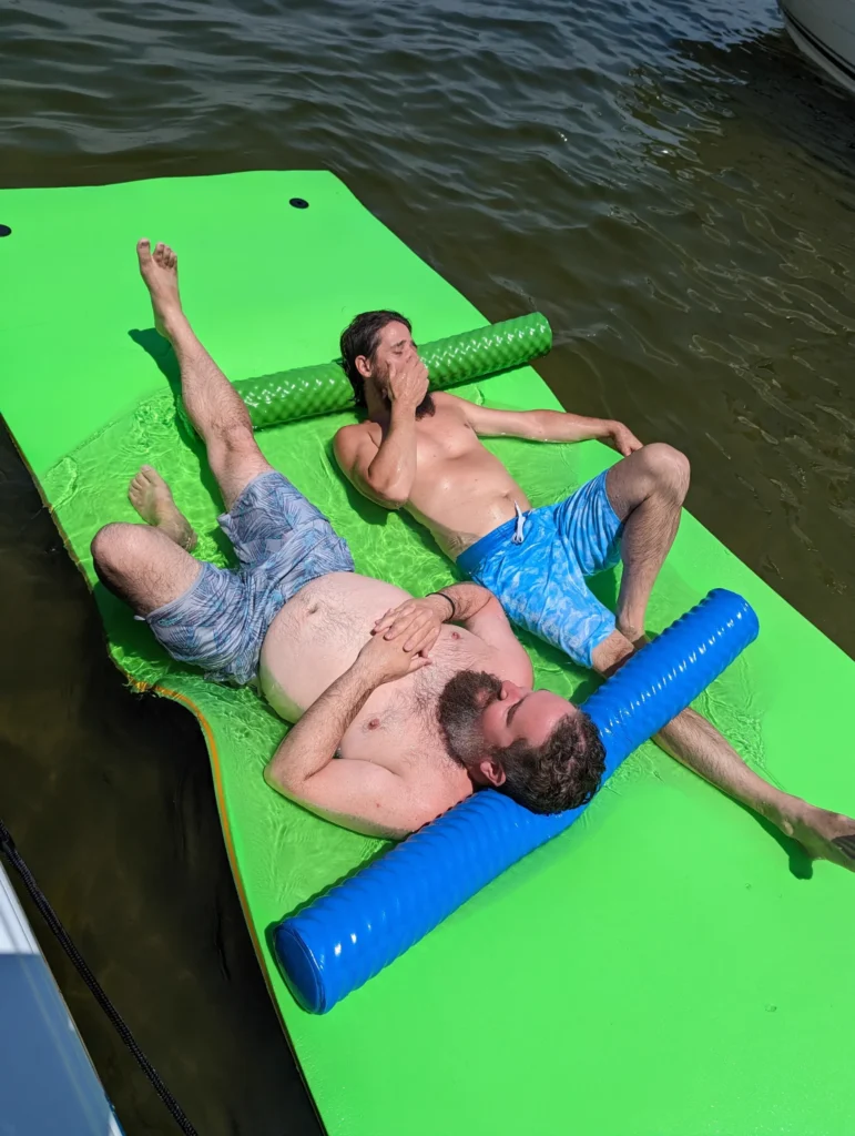 Guests relaxing on a floating mat at a sandbar