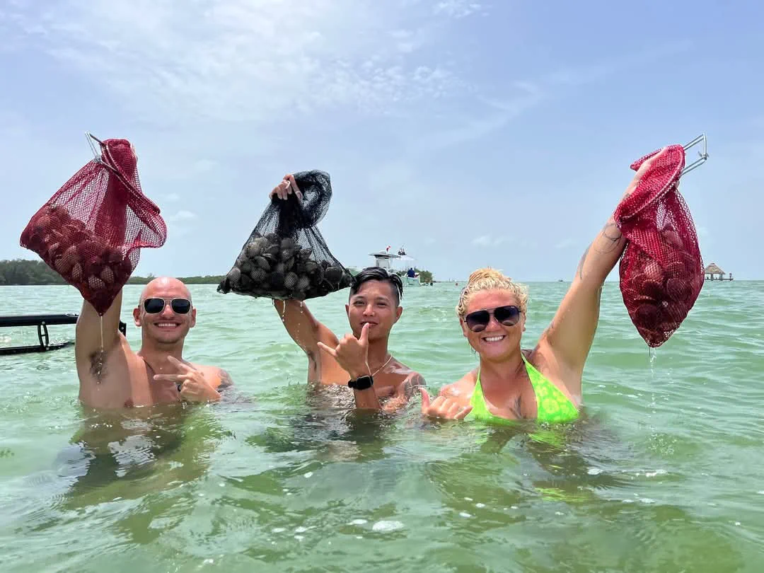 An Aquatic Escapes group holding up their bags of bay scallops