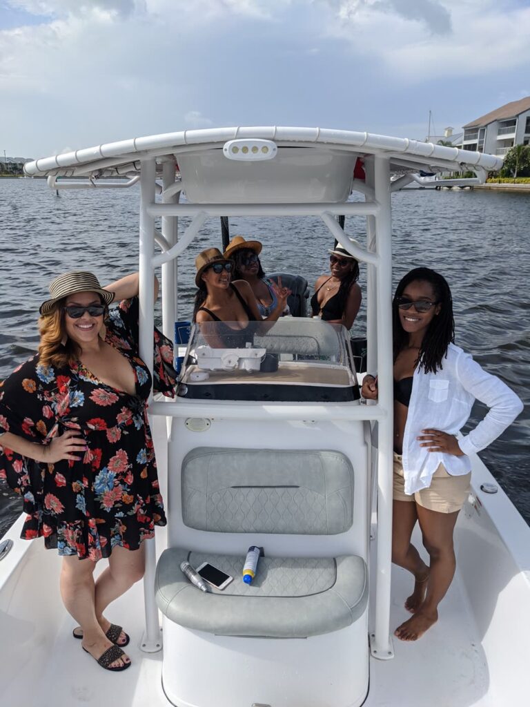 Three women on the bow of the charter boat dressed for a sunset cruise on Tampa Bay