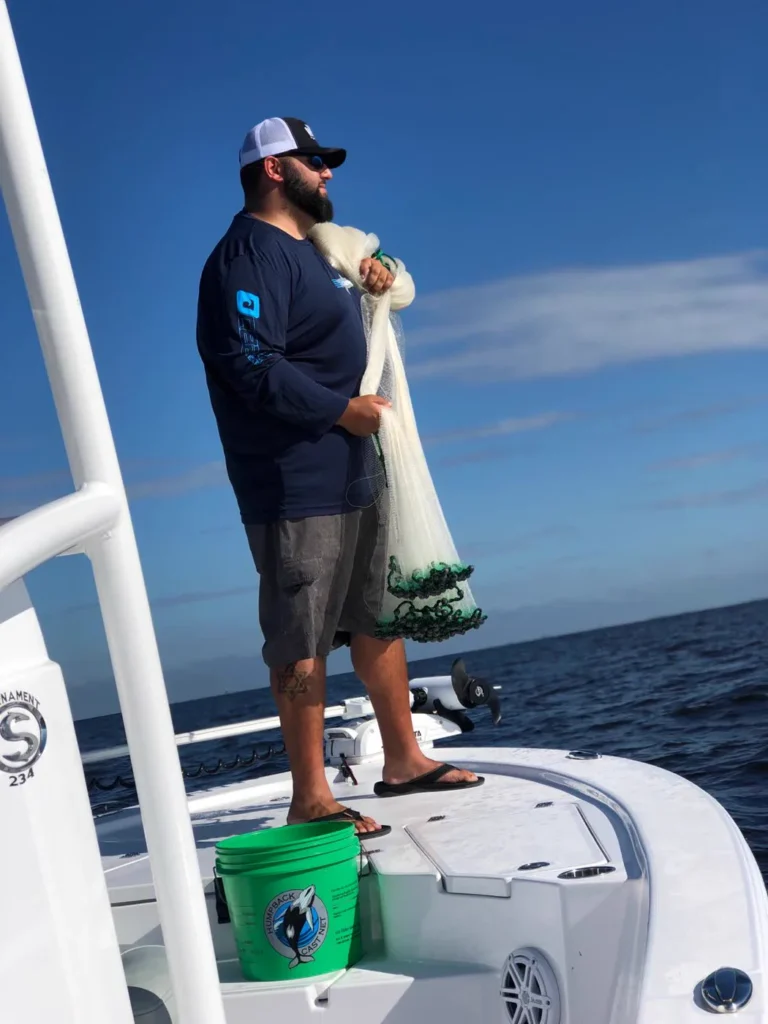 Cast net gathered and ready to throw from the bow of the charter boat