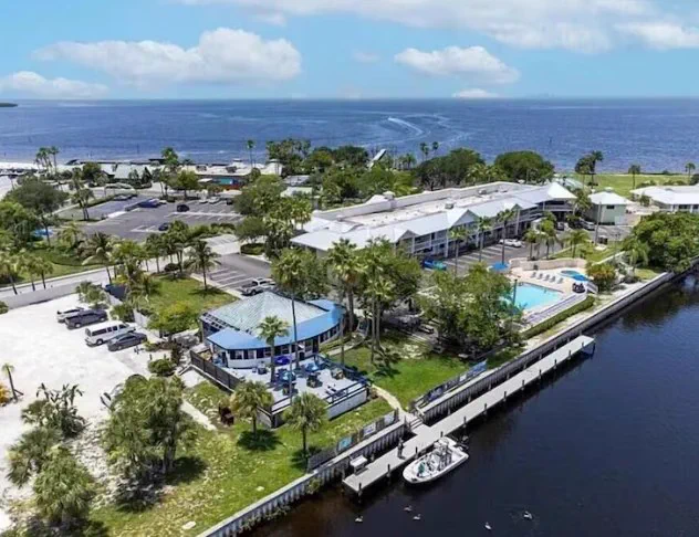 Aerial view of Hook's Bar and Grill in Ruskin, with the pool and the long dock on the Little Manatee River where charter guests board.