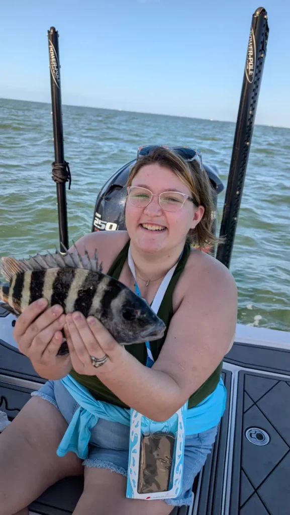 Angler on the boat holding a sheepshead caught on a winter fishing charter in Tampa Bay