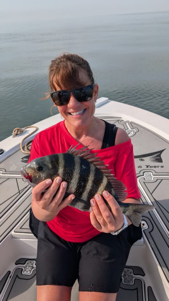 Angler holding a sheepshead caught on a Tampa Bay winter fishing charter