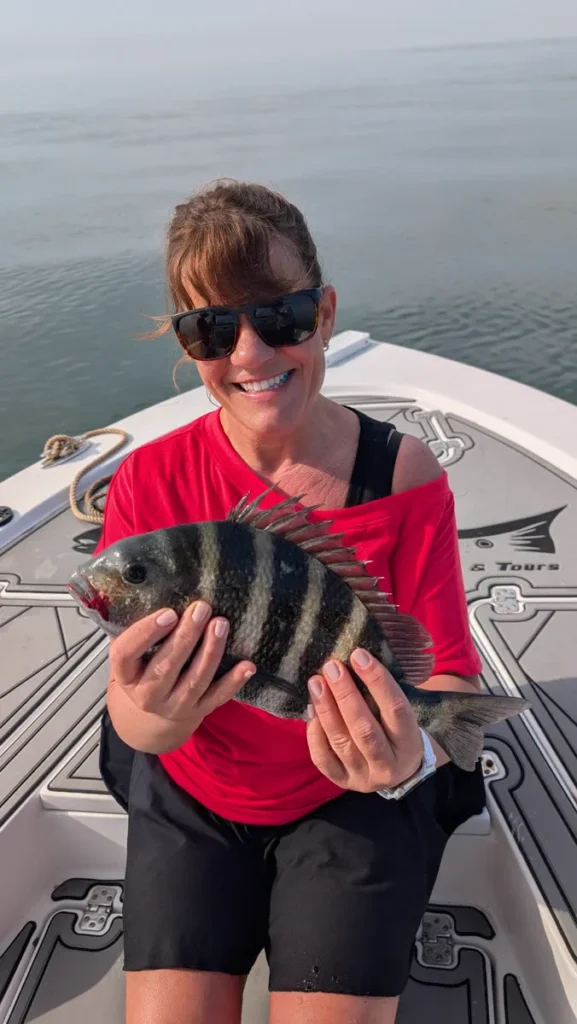 Angler holding a sheepshead caught on a Tampa Bay winter fishing charter