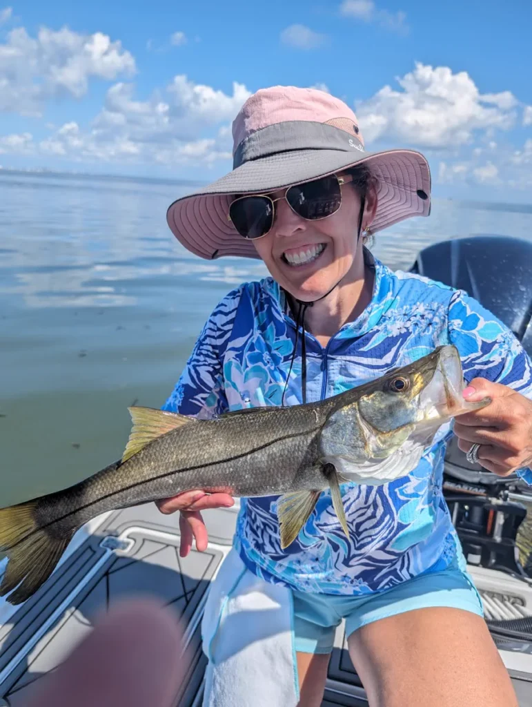Angler holding a snook caught on a Tampa Bay inshore fishing charter