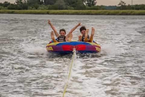 Two riders towed on an inflatable tube on an island hopping trip